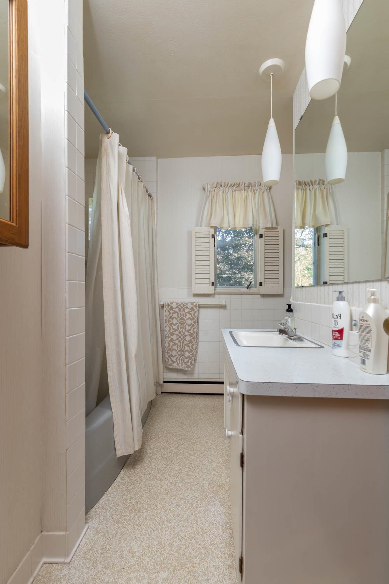 3814 Brookview Road Rockford, IL 61107 - Photo 16 of 34 a bathroom with a sink a mirror and a shower
