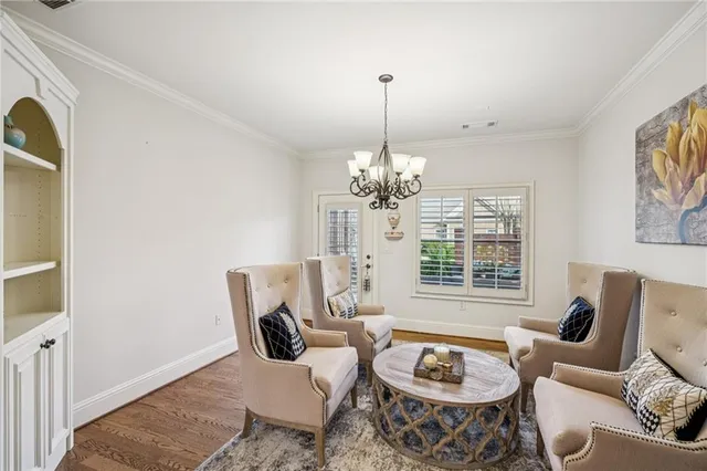 a living room with furniture a window and a chandelier