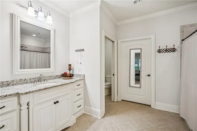 a spacious bathroom with a granite countertop sink a mirror and a