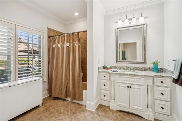 a bathroom with a granite countertop sink vanity mirror next to a window