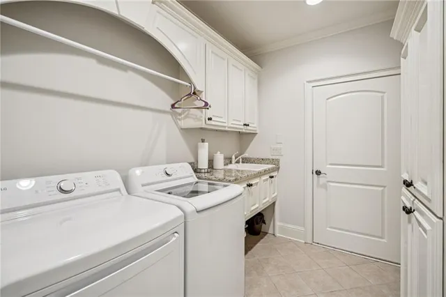 a view of washer and dryer with bathroom in the background
