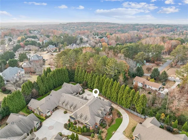 an aerial view of a house with yard and mountain view in back