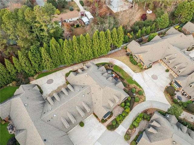 an aerial view of a swimming pool with a yard