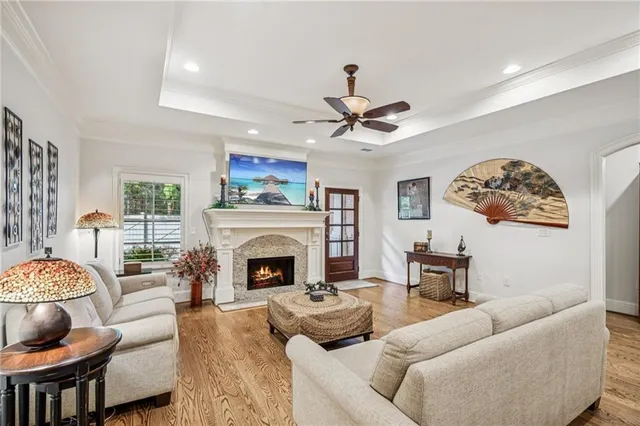 a living room with furniture a fireplace and a flat screen tv