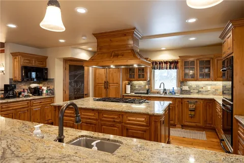 a kitchen with stainless steel appliances granite countertop a sink and cabinets