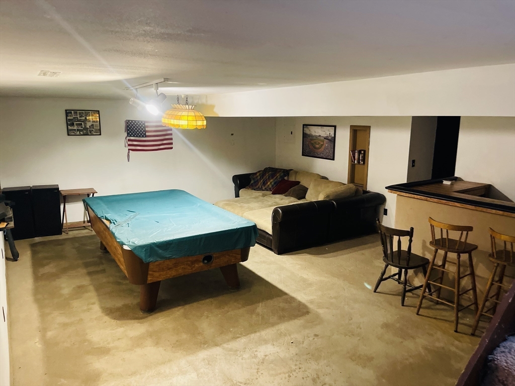 75 Frost Road Tyngsboro, MA 01879 - Photo 11 of 15 a living room with furniture pool table and a flat screen tv