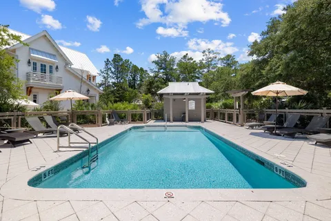 a view of house with swimming pool outdoor seating