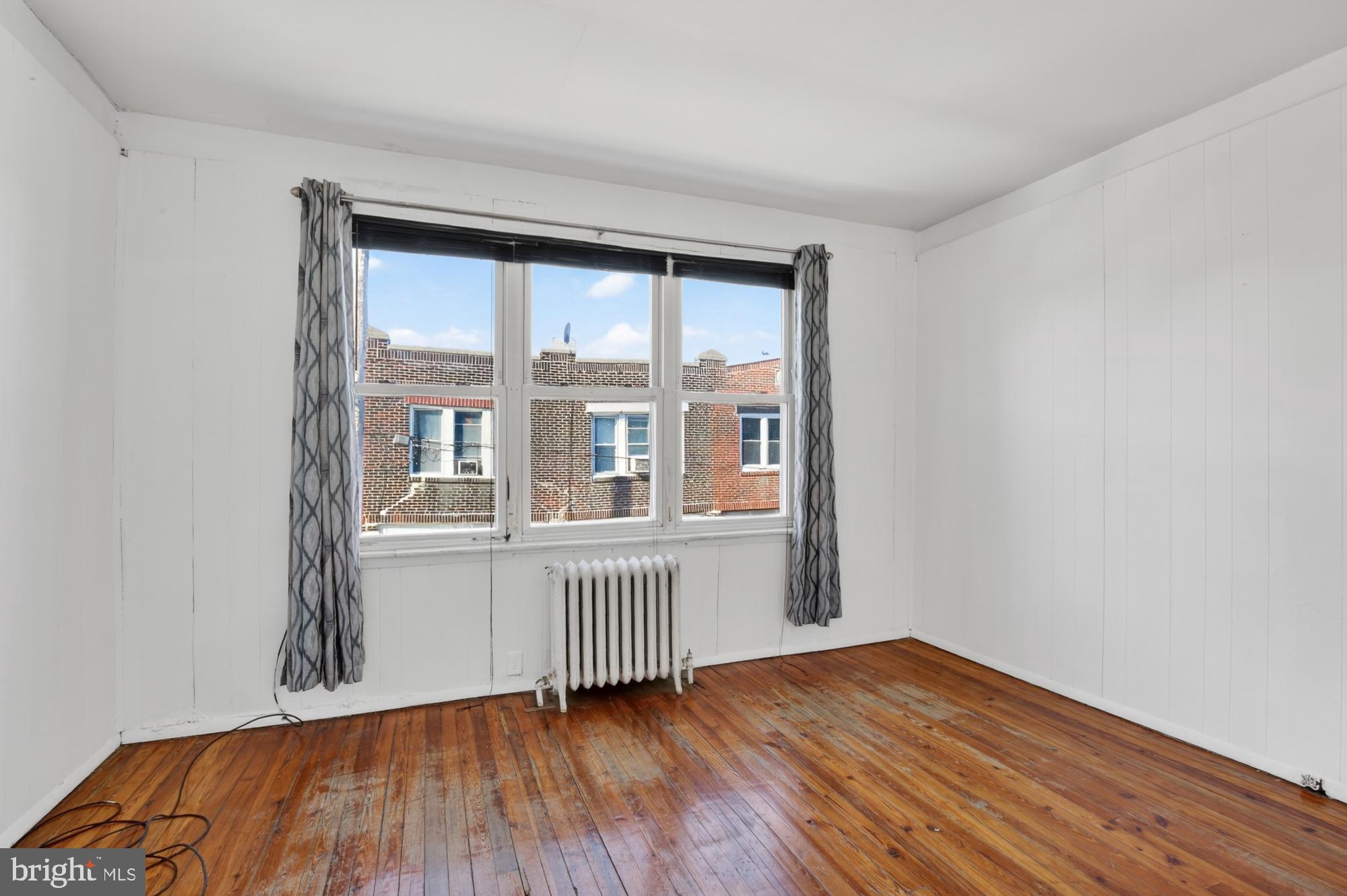 1617 South Newkirk Street Philadelphia, PA 19145 - Photo 18 of 22 a view of an empty room with wooden floor and a window
