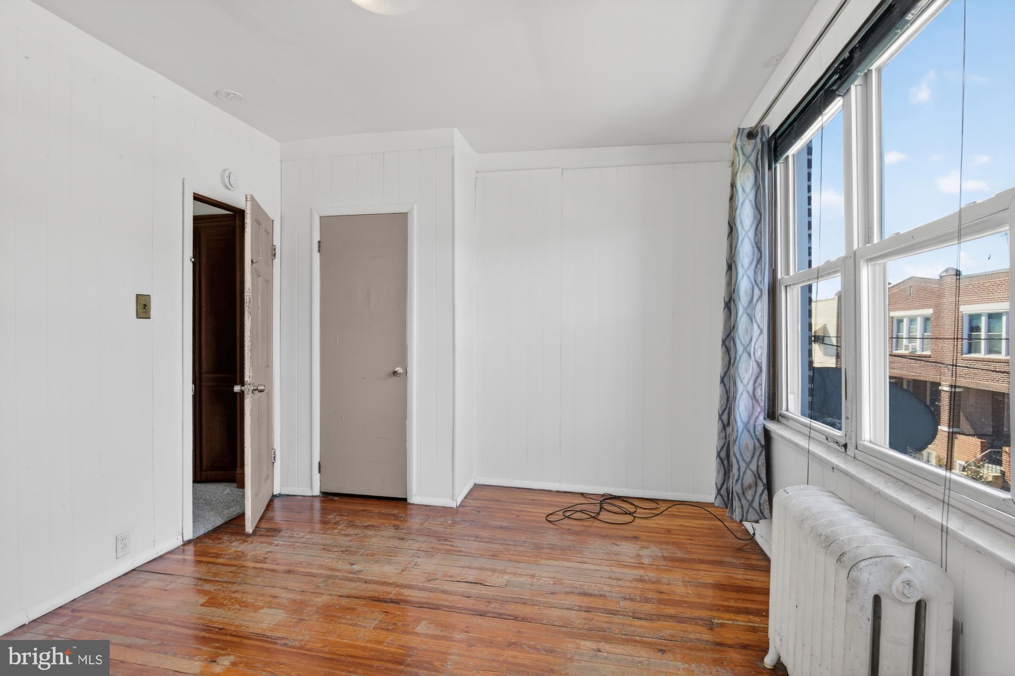 1617 South Newkirk Street Philadelphia, PA 19145 - Photo 20 of 22 a view of an empty room with wooden floor and a window