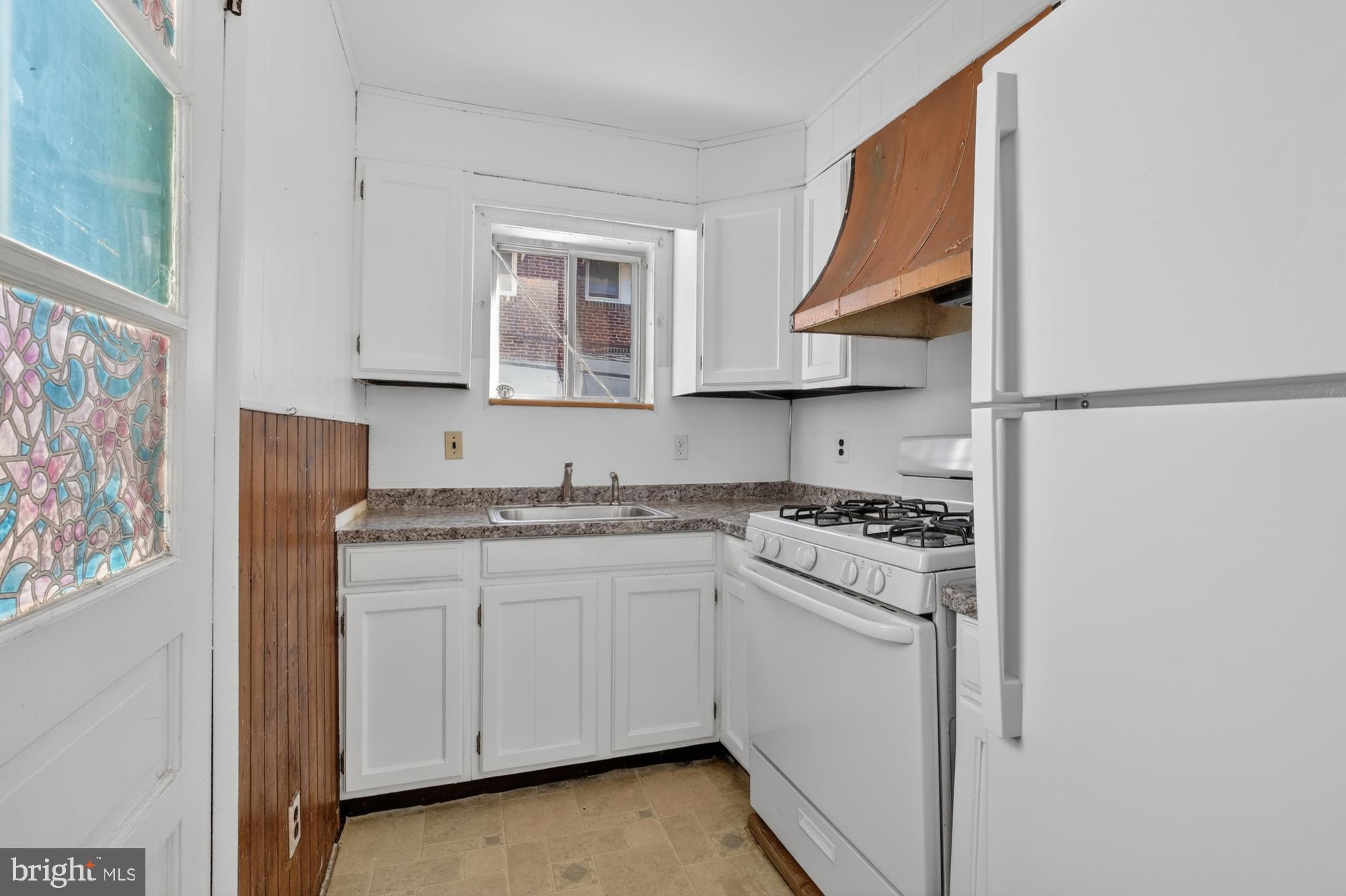 1617 South Newkirk Street Philadelphia, PA 19145 - Photo 7 of 22 a kitchen with stainless steel appliances granite countertop a sink and a stove with white countertops