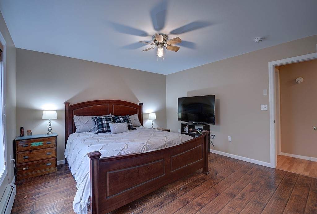 218 New Boston Road Sturbridge, MA 01566 - Photo 18 of 23 a bedroom with a bed and a flat screen tv