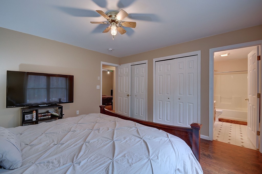 218 New Boston Road Sturbridge, MA 01566 - Photo 19 of 23 a bedroom with a bed and a flat tv screen on a dresser