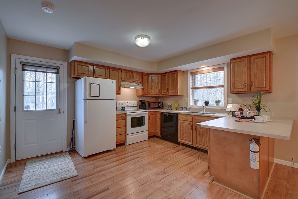 218 New Boston Road Sturbridge, MA 01566 - Photo 5 of 23 a kitchen with stainless steel appliances granite countertop a refrigerator a sink dishwasher a stove top oven a refrigerator with island and cabinets