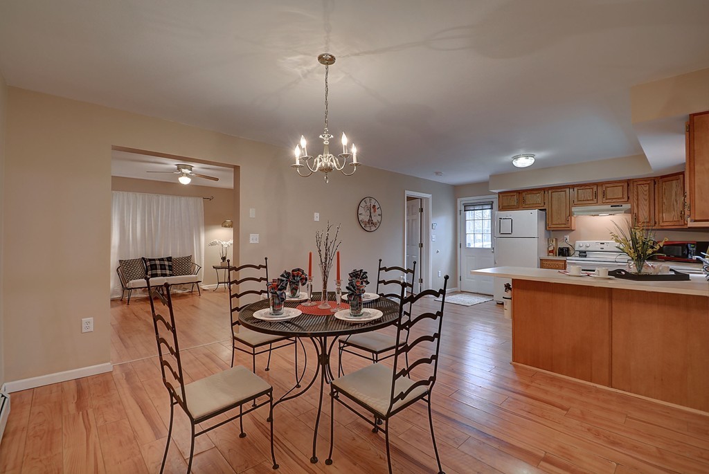 218 New Boston Road Sturbridge, MA 01566 - Photo 7 of 23 a view of a dining room with furniture and wooden floor