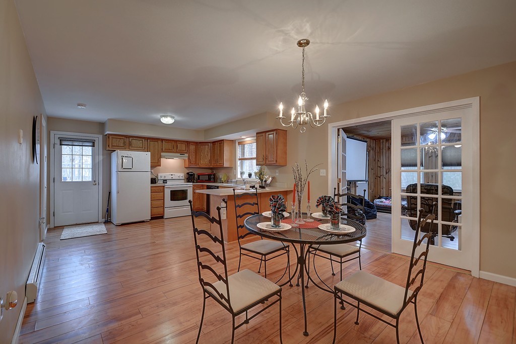 218 New Boston Road Sturbridge, MA 01566 - Photo 8 of 23 a view of a dining room with furniture and wooden floor