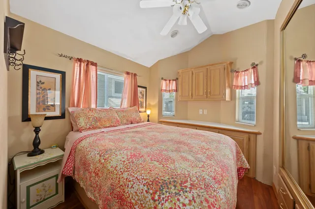 a bedroom with a large bed and a chandelier