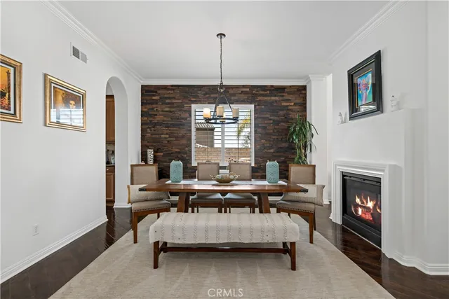 a view of a dining room with furniture a chandelier and wooden floor