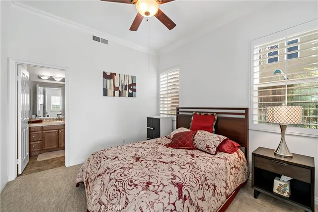 a spacious bathroom with a granite countertop double vanity sink a mirror and a toilet