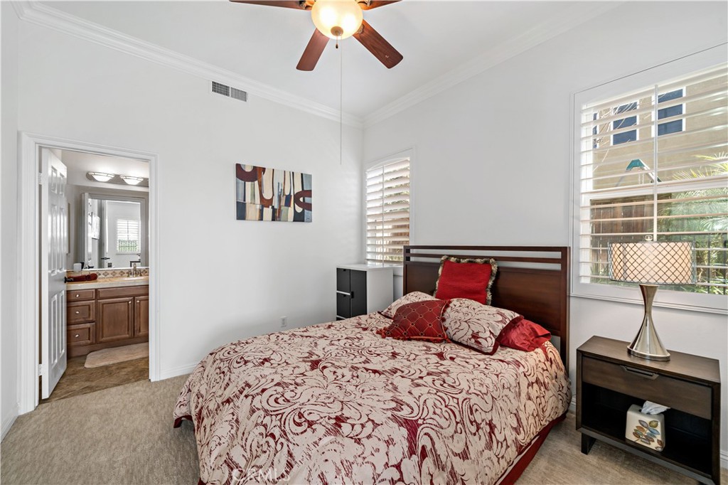 16423 Village Meadow Drive Riverside, CA 92503 - Photo 29 of 63 a bedroom with a bed and a lamp on a dresser
