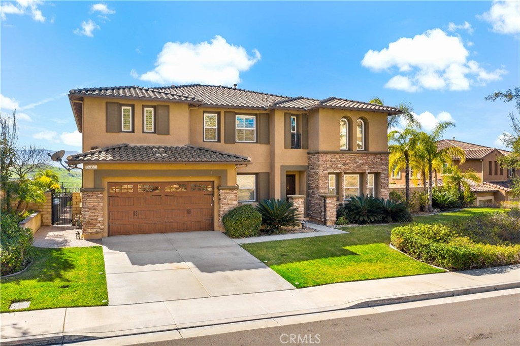 16423 Village Meadow Drive Riverside, CA 92503 - Photo 3 of 63 a front view of a house with a yard and potted plants