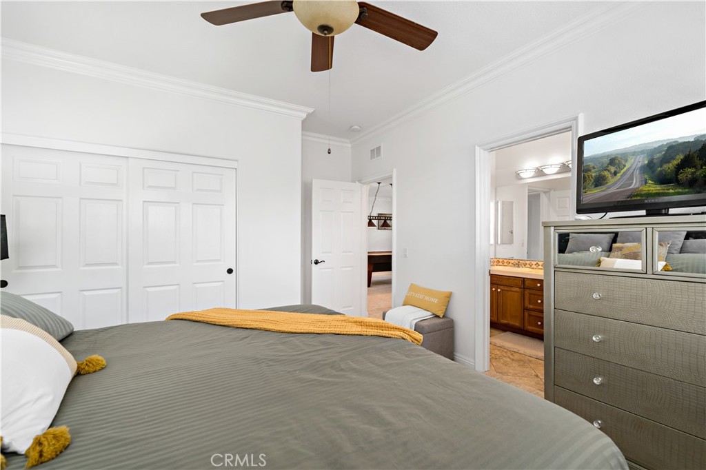 16423 Village Meadow Drive Riverside, CA 92503 - Photo 36 of 63 a bedroom with a bed and flat screen tv