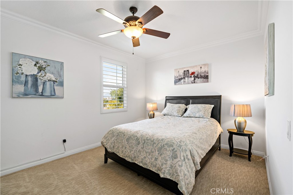 16423 Village Meadow Drive Riverside, CA 92503 - Photo 40 of 63 a bedroom with a bed and a chandelier