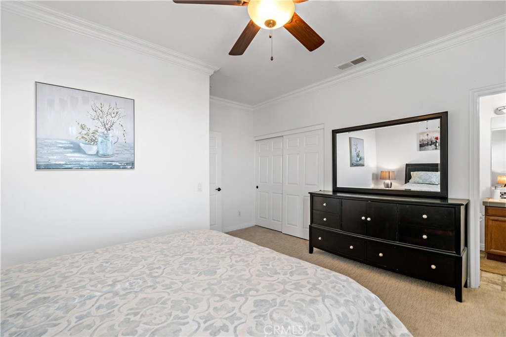 16423 Village Meadow Drive Riverside, CA 92503 - Photo 41 of 63 a bedroom with a bed and a mirror on dresser