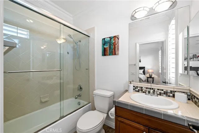 a spacious bathroom with double vanity and a bathtub