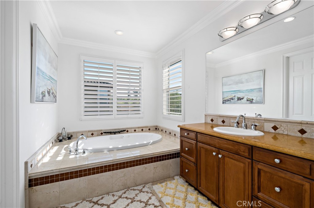 16423 Village Meadow Drive Riverside, CA 92503 - Photo 48 of 63 a spacious bathroom with double vanity and a bathtub
