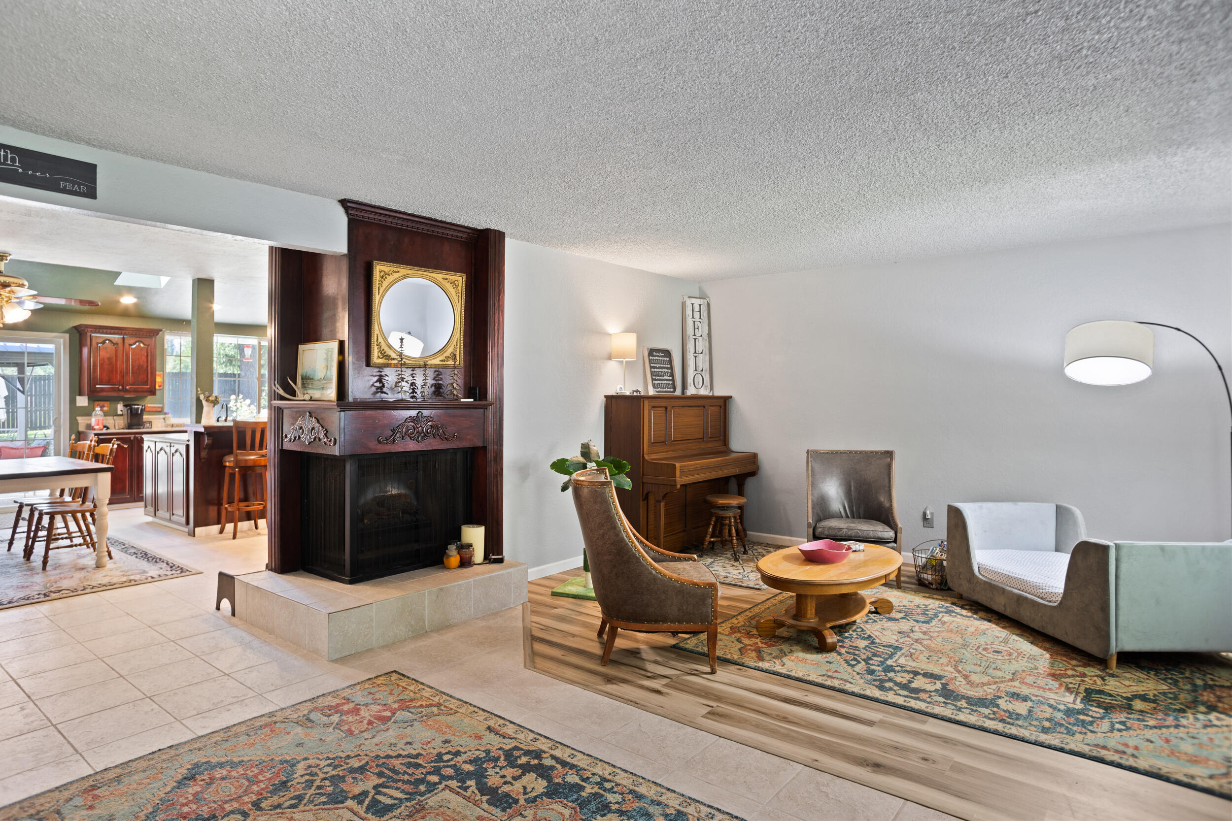 255 Queens Branch Road Rogue River, OR 97537 - Photo 6 of 60 a living room with furniture a piano and a fireplace