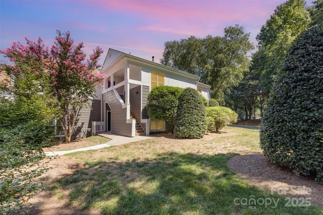a view of a house with a yard and garage