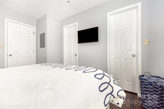 a bedroom with a bed and a flat screen tv