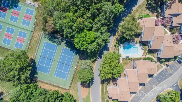 an aerial view of residential houses with outdoor space