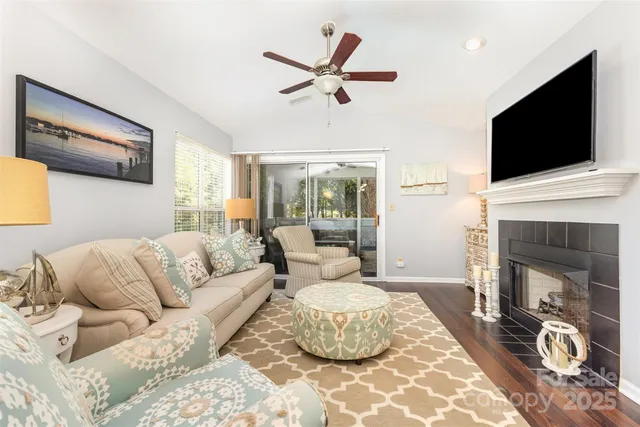 a living room with furniture a flat screen tv and a fireplace