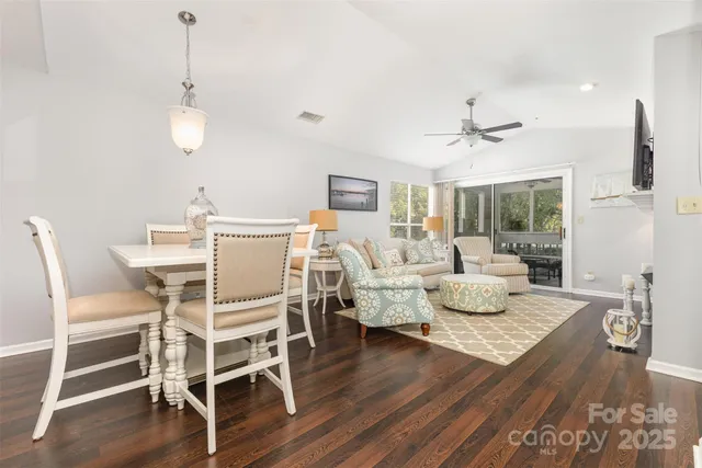 a view of a dining room with furniture wooden floor and chandelier
