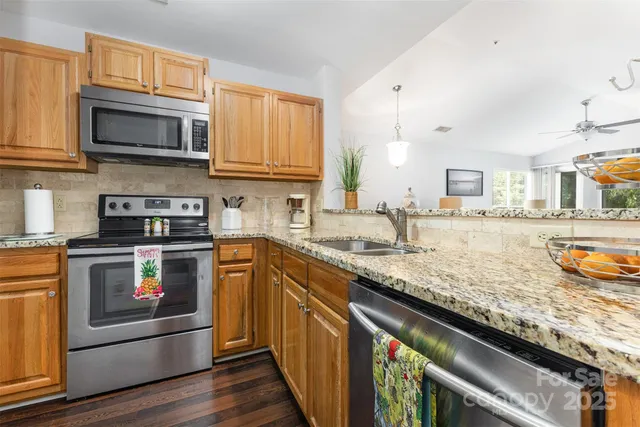 a kitchen with stainless steel appliances granite countertop a stove and a sink