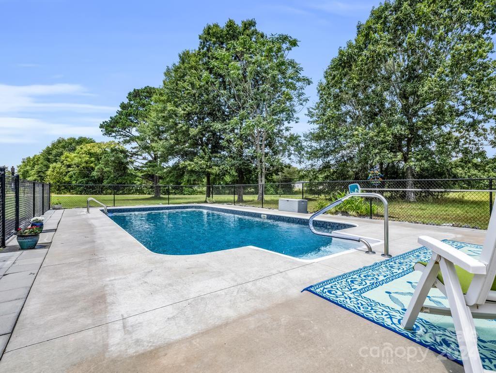 1629 State Line Road Mooresboro, NC 28114 - Photo 30 of 43 a view of a swimming pool with a lounge chair