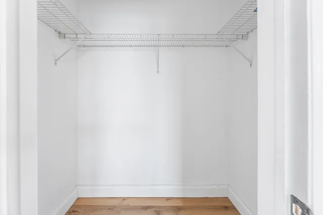 a view of a room with wooden floor