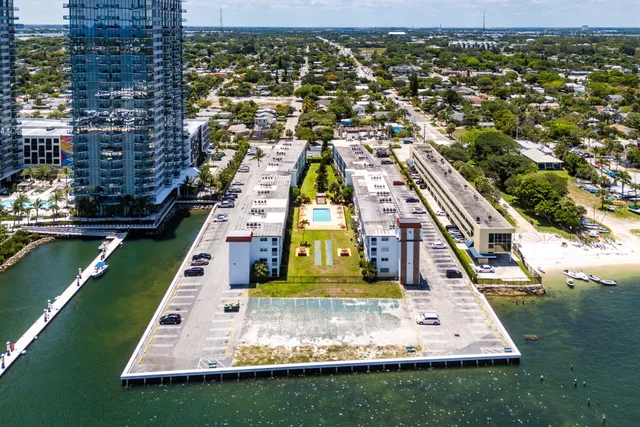an aerial view of multiple houses with yard
