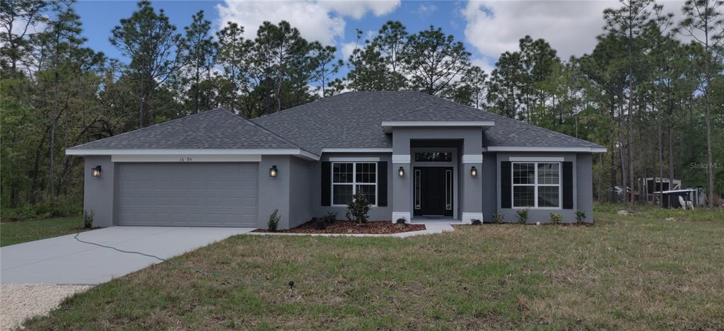 16295 Pomp Parkway Weeki Wachee, FL 34614 - Photo 1 of 28 a front view of a house with yard and trees in the background