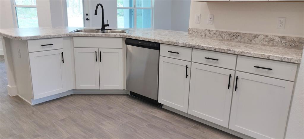 16295 Pomp Parkway Weeki Wachee, FL 34614 - Photo 12 of 28 a kitchen with granite countertop cabinets and white appliances