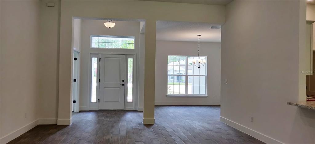 16295 Pomp Parkway Weeki Wachee, FL 34614 - Photo 2 of 28 an empty room with wooden floor and windows