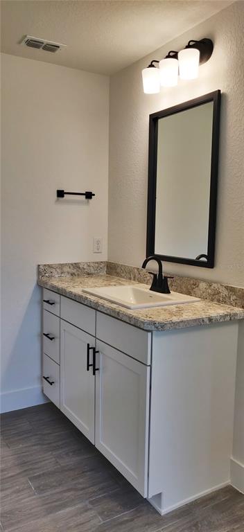 16295 Pomp Parkway Weeki Wachee, FL 34614 - Photo 22 of 28 a bathroom with a granite countertop sink vanity and mirror
