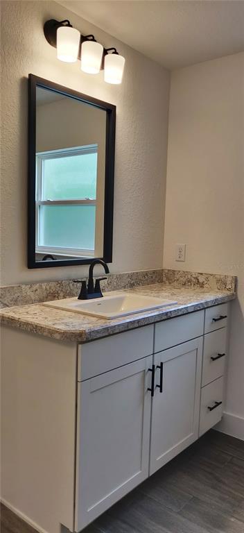 16295 Pomp Parkway Weeki Wachee, FL 34614 - Photo 23 of 28 a bathroom with a granite countertop sink and a mirror