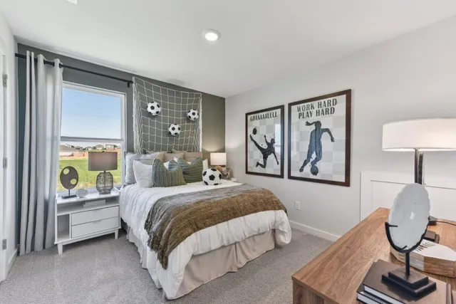 a bedroom with a bed painting on wall and a window