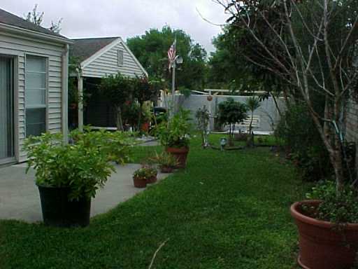 7126 Taos Drive Corpus Christi, TX 78413 - Photo 2 of 2 a front view of a house with a garden