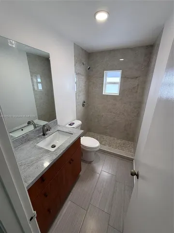 a view of bathroom with a sink and mirror