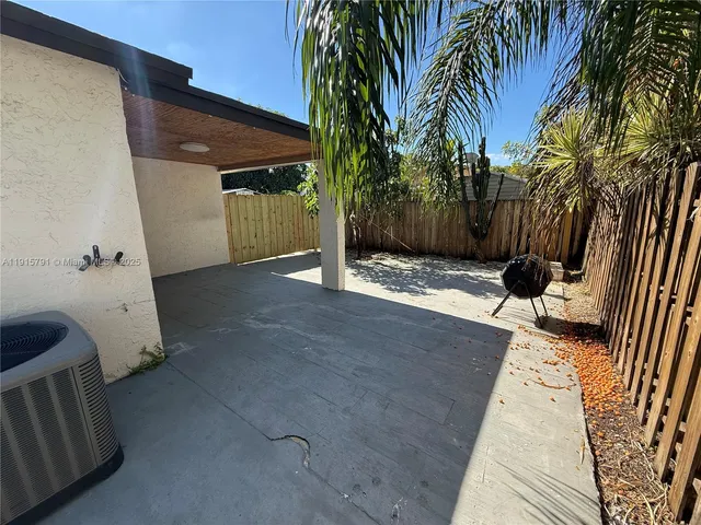 an aerial view of a house with a backyard