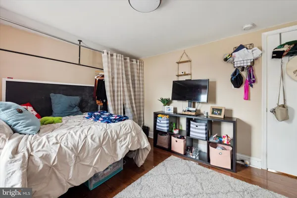 a bedroom with a bed and a tv