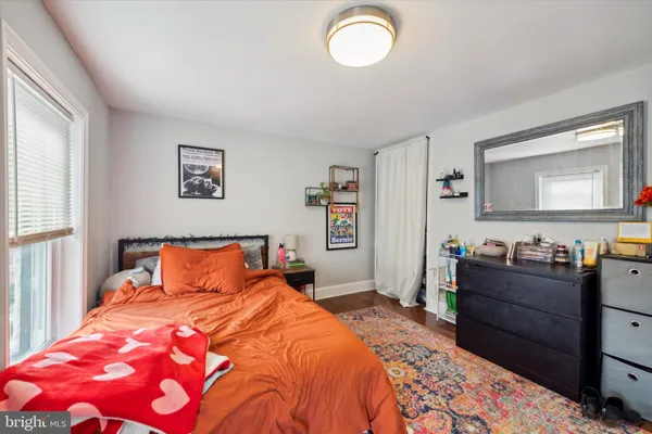 a bedroom with a bed and a dresser